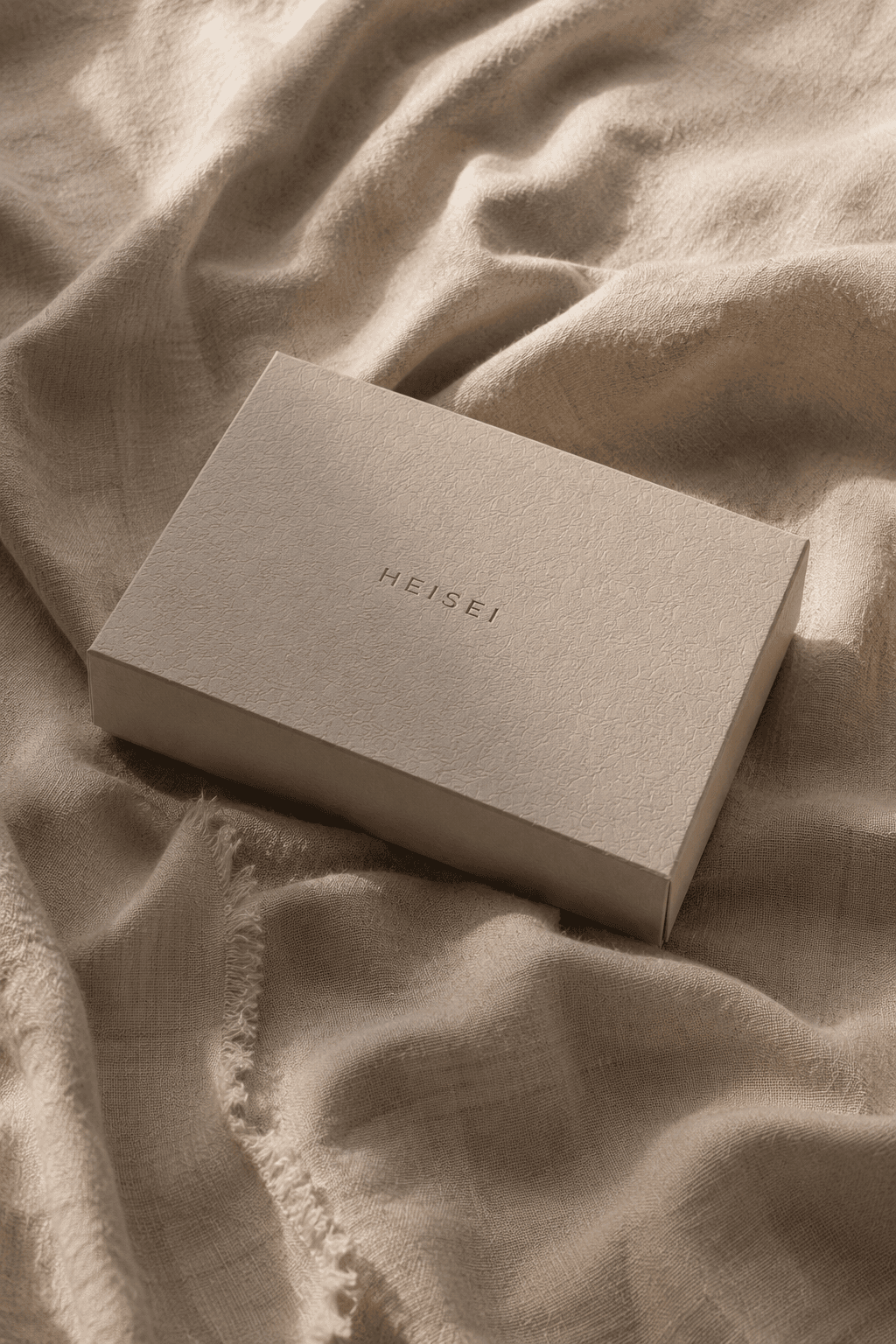 HEISEI packaging on draped natural linen
